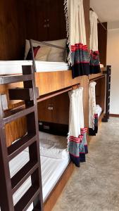 a room with three bunk beds with socks on them at Baan Heart Thai in Chiang Mai