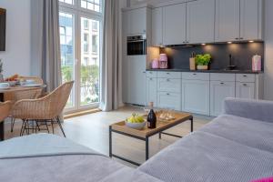 a kitchen and living room with a couch and a table at Steuerbord in Westerland (Sylt)