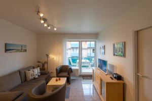 a living room with a couch and a tv at ST33-22 - Appartement Typ D in Dorum Neufeld