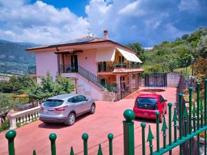 two cars parked in front of a house at Villa Giulia - Giungano - Cilento in Giungano