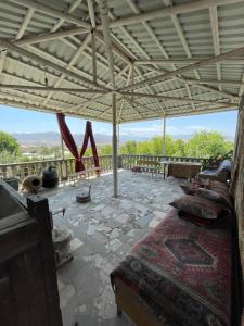 a room with a bed and a balcony with a view at Zoratc QARER in Sisian