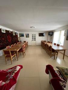 a large room with wooden tables and chairs at Zoratc QARER in Sisian