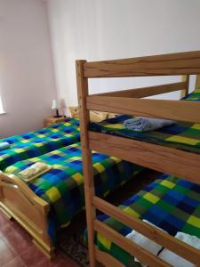a bunk bed with a green and blue checkered sheets at Zoratc QARER in Sisian +11 photos