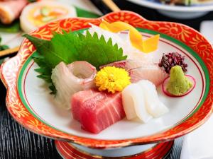 a plate of food with sushi on a table at AsoTsuruya in Aso +69 photos