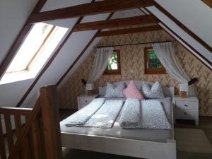 a bedroom with two beds in a attic at Nussbaumerhof 