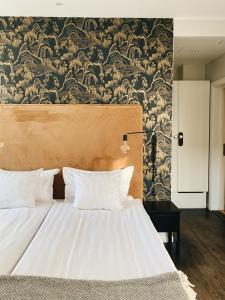 a bedroom with a large bed with a wall mural at Kalk Hotel in Visby