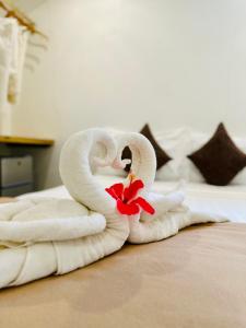 a towel animal shaped like a swan on a bed at El Nido Coco Resort in El Nido
