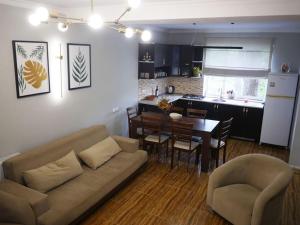 a living room and kitchen with a couch and a table at The Lookout Grigoleti in Grigoleti