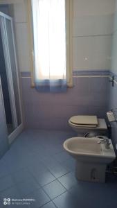 a bathroom with a toilet and a sink at CAMERE LA COMETA in Marsala