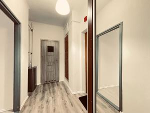 an empty hallway with a mirror and a door at EASY RENT- Lublin Chopina CityCentre Free Parking 24h Check-in in Lublin
