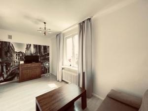 a living room with a couch and a table at EASY RENT- Lublin Chopina CityCentre Free Parking 24h Check-in in Lublin