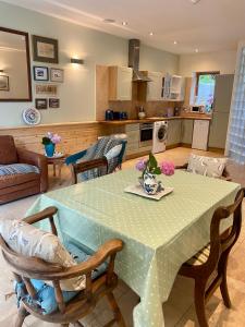 a kitchen and living room with a table and chairs at Portelet Bay in St Brelade