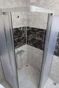 a shower with a glass door in a bathroom at power suit in Fethiye