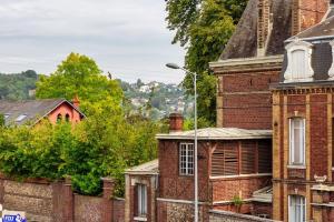 an old brick building with a street light in front of it at Saint Maur * F2* beau logement entier in Rouen