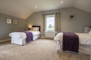 A bed or beds in a room at The Old Hay Barn