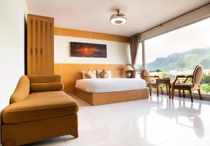 a bedroom with a bed and a table and chairs at Conson Hotel in Con Dao