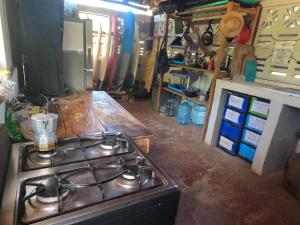 a kitchen with a stove and a counter top at Palapa in Transito