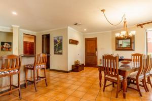 a kitchen and dining room with a table and chairs at Bougainvillea 5102 Luxury Apartment - Reserva Conchal in Playa Conchal