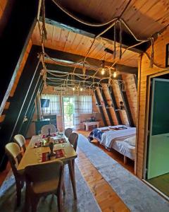 a bedroom with a bed and a table and chairs at Vilat Pllumaj in Gropat e Selcës