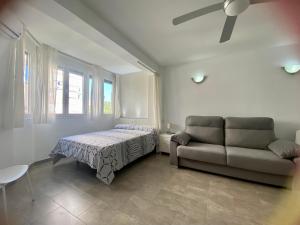 ein Wohnzimmer mit einem Bett und einem Sofa in der Unterkunft Estudio Rodri By Solymar Holiday in Torre del Mar