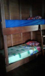 two bunk beds in a room with blue sheets at Nyang Ebay Surf Camp siberut front E-Bay,Beng-Bengs,Pitstops,Bank Vaults,Nipussi in Masokut