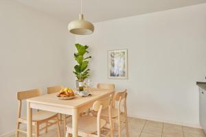 a white dining room with a table and chairs at NEW-Mona - idyllisches Örtchen in Buchen