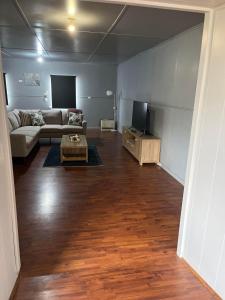 a living room with a couch and a tv at House on Ryan in Broken Hill