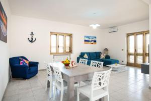 a living room with a table and chairs at Zion Mare in Soverato Superiore