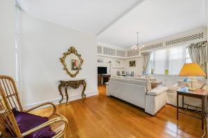 a living room with a couch and a table at HydePark Queens Gate Apt in London