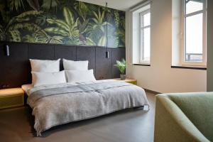 a bedroom with a large bed with a painting on the wall at Schlachte 22 Living in Bremen