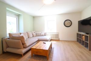 a living room with a couch and a coffee table at Montfort Apartments - Feldkirch in Feldkirch