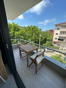 a table and chairs on a balcony with a view at Hostel Amasra in Bartın
