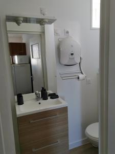 a bathroom with a sink and a toilet at Appartement "La Marine" vue mer in Saint-Pair-sur-Mer