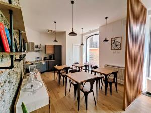 a dining room with tables and chairs and a kitchen at Il Canto di Ligea in Lamezia Terme