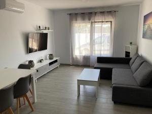 a living room with a couch and a table at Villa El Lagar in Novo Sancti Petri