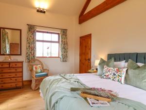 een slaapkamer met een bed, een dressoir en een raam bij Rowtor in Matlock