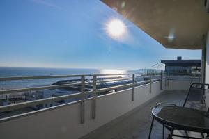 d'un balcon avec une table et une vue sur l'océan. dans l'établissement Grömitz- Center I App 767 inkl WLAN, à Grömitz