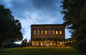 a large building with lights in front of it at Bailbrook House Hotel, Bath in Bath