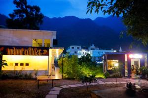 a building with a sign on it at night at Indian Culture in Rishīkesh