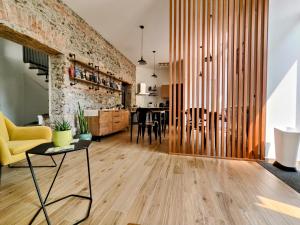 a living room with wooden floors and a brick wall at Il Canto di Ligea in Lamezia Terme