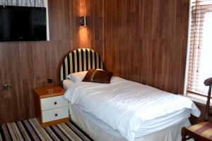 Tempat tidur dalam kamar di Ely Guest House