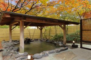 a gazebo with a pond in a yard at Tachibanaya in Tsuruoka