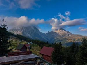 a view of a mountain in the distance with a house at Komovi - Montenegrina Mountain house in Kolašin +19 photos
