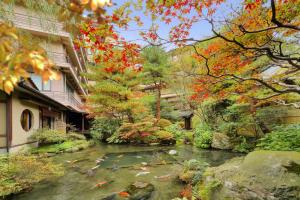 un jardin avec un étang avec des cerfs-volants dans l'établissement Tachibanaya, à Tsuruoka