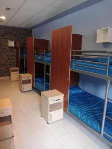 a room with several bunk beds in a building at Albergue de Peregrinos Villa de Luarca in Luarca