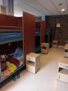 a dorm room with bunk beds and boxes at Albergue de Peregrinos Villa de Luarca in Luarca