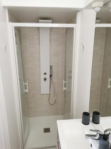 a bathroom with a shower with a glass door at Appartement "La Marine" vue mer in Saint-Pair-sur-Mer