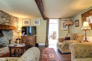 a living room with a couch and a tv at Browns Lane in Woodstock