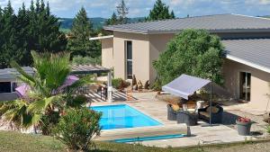 a house with a swimming pool in a yard at Millésime in Perville