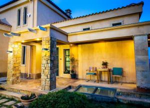 ein Haus mit einer Terrasse mit einem Tisch und Stühlen in der Unterkunft Villa Porgio Mountain View in Serres